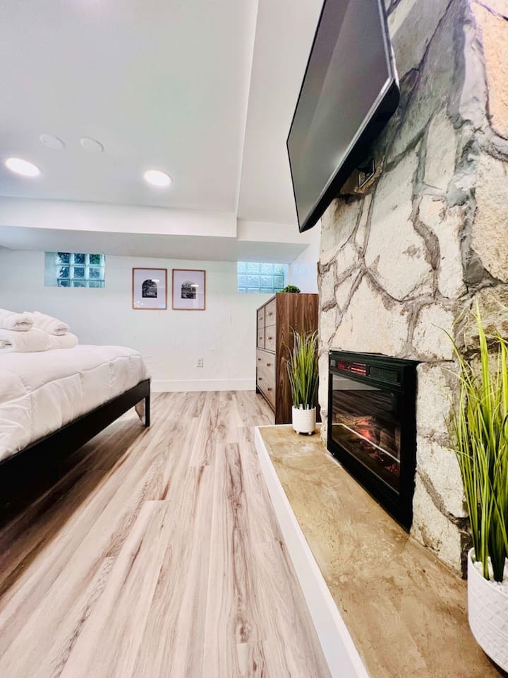 Spacious queen-sized bedroom with a dedicated working space and a TV, offering the perfect blend of comfort, productivity, and entertainment.