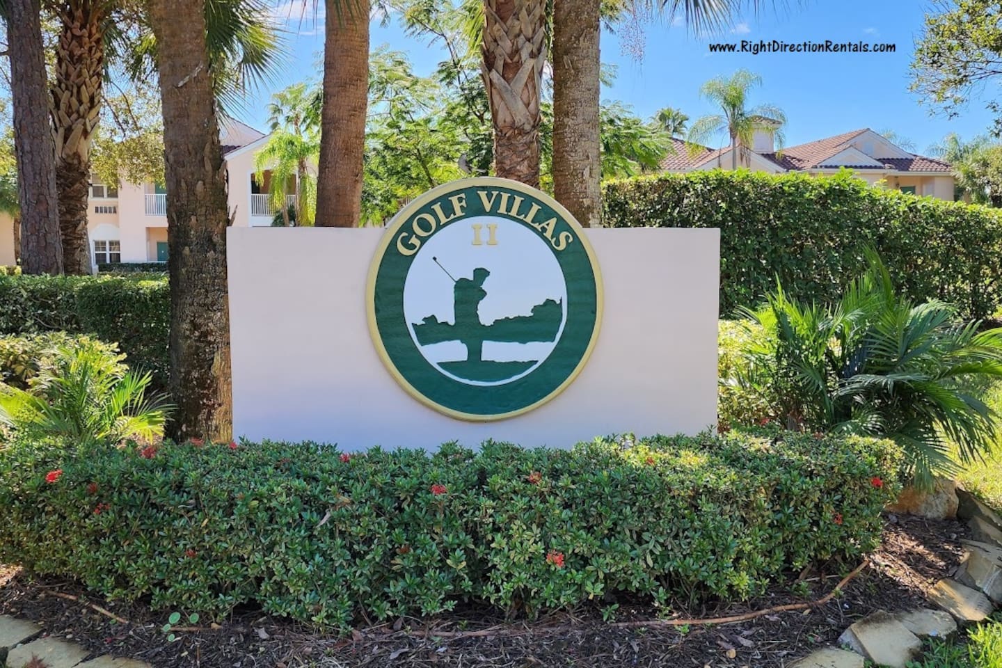 Golf Villas community entrance sign surrounded by tropical landscaping.