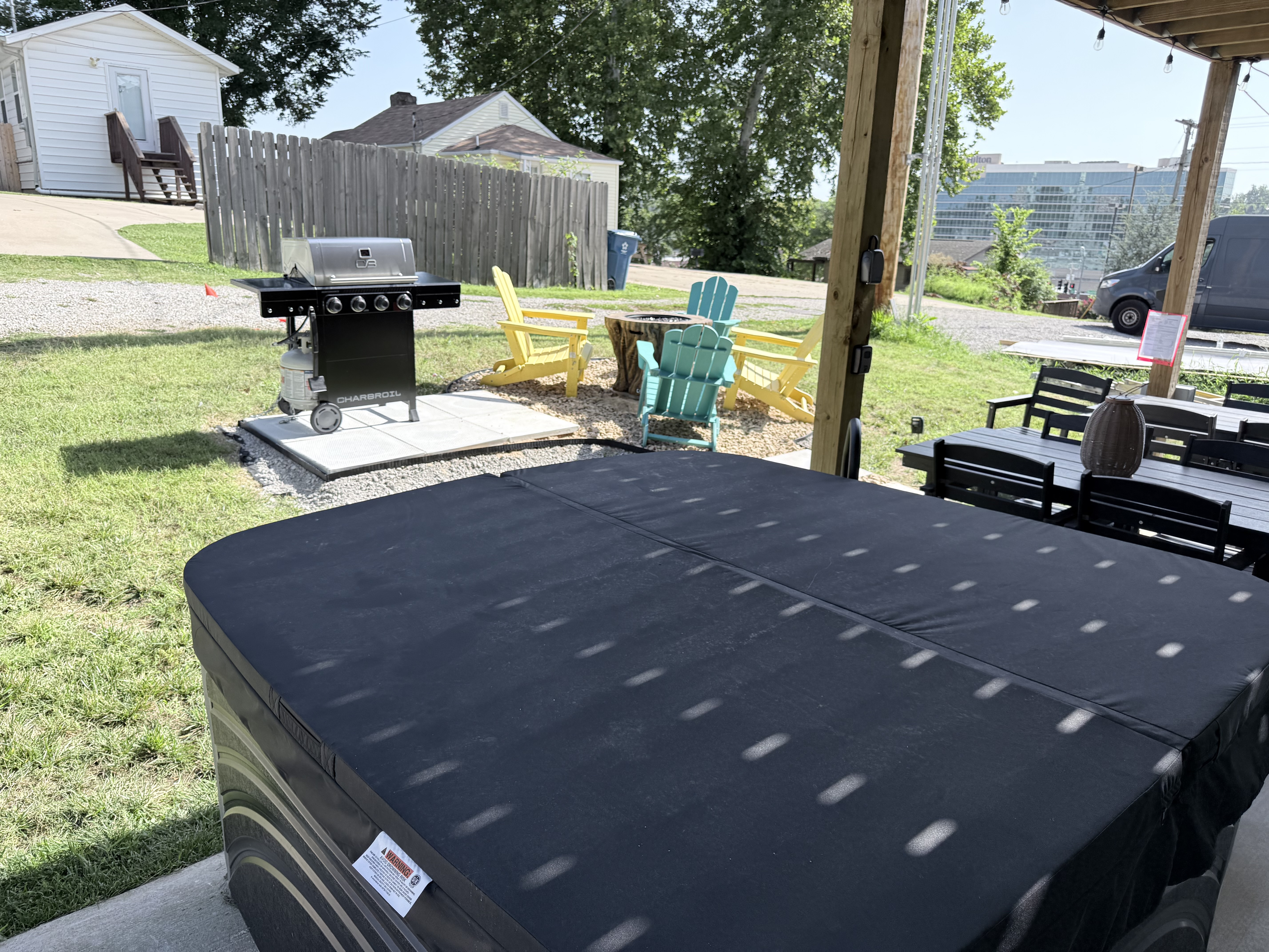 Hot tub with cover overlooking fire pit. Enjoy those cooler evenings with the entire family outside. Convention center in background