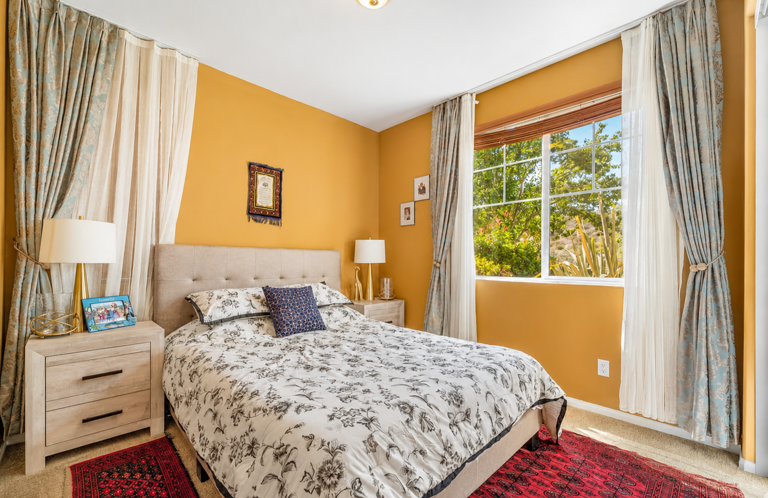 Warm bedroom with soft bedding, sunny windows, and a calm place to rest.