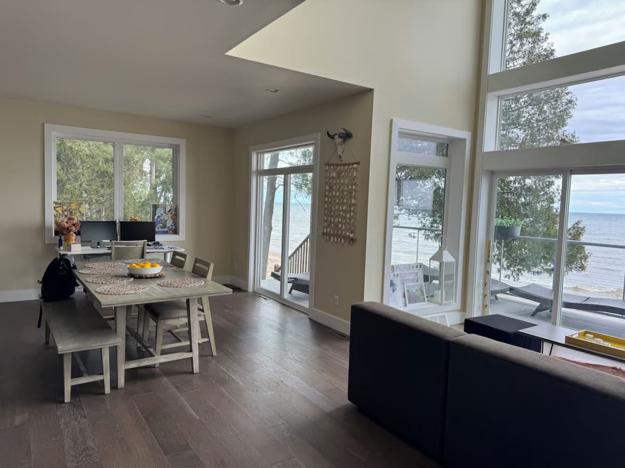 Dining nook by large windows, perfect for meals w/ a bright, airy feel