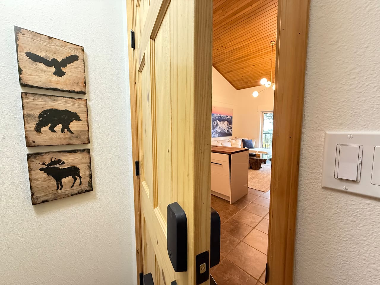 Mountain Theme Welcome: The entryway features charming local wildlife art and provides easy access to the main living areas of the mountain retreat property.
