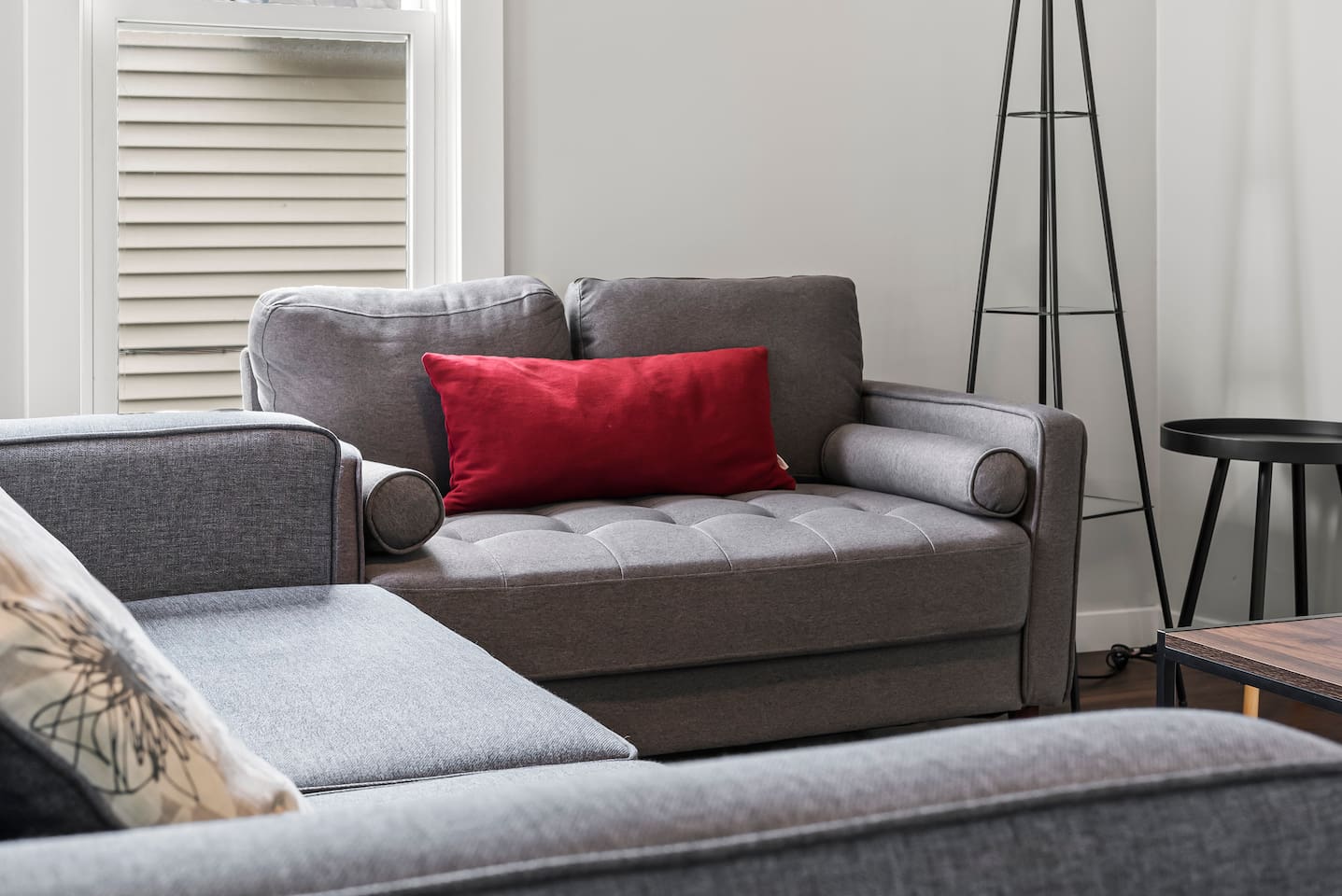 Relax in this light-filled lounge, complete with a sleek ceiling fan and cozy ambiance.