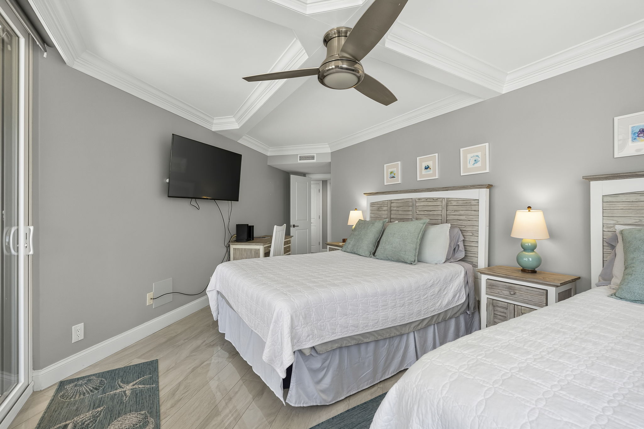 Guest bedroom with two full size beds and balcony access
