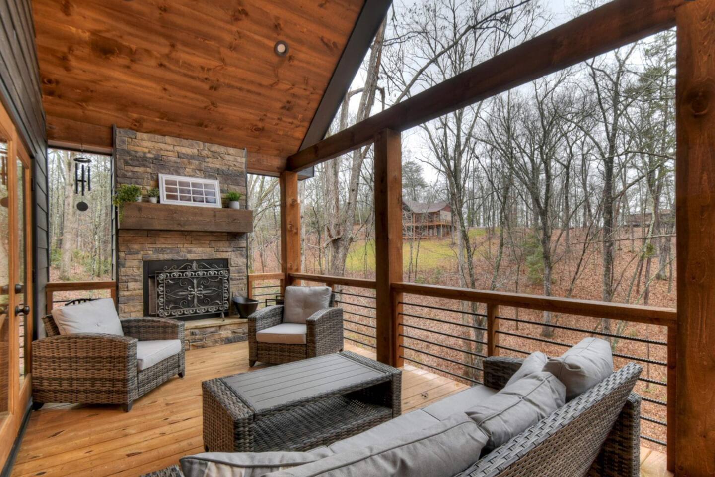 Outdoor fire place with seating for friends and family to gather.  This deck level also has the grill, table, and swing on it.