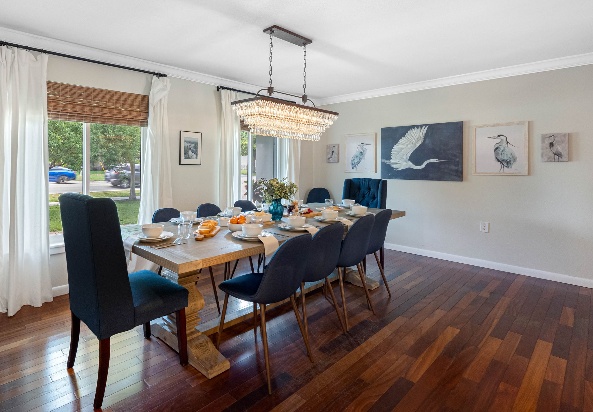 Charming details like the crystal chandelier and farmhouse barn doors make this dining space truly unique.