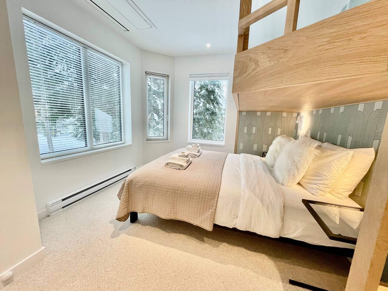 Bedroom#3 on 2nd floor has surround windows that immerse you in the scenic backdrop of Whistler mountain & glacier fed Fitzsimmons Creek. It’s like sleeping in Winter Wonderland. Sleeps up to 3 Adults:  Queen + built-in overhead adult size Twin XL
