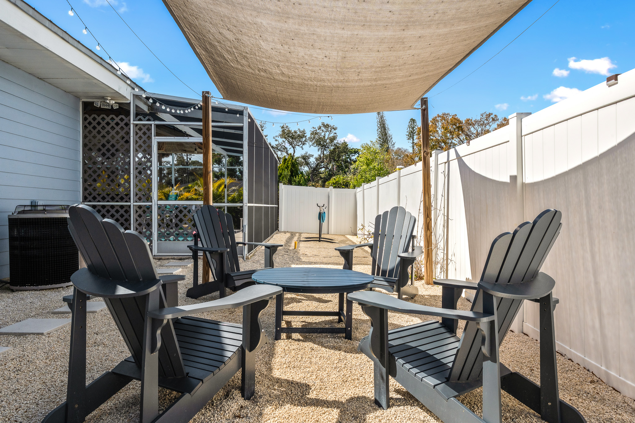 Shaded lounge area with Adirondack chairs and a coffee table — perfect for hanging out together