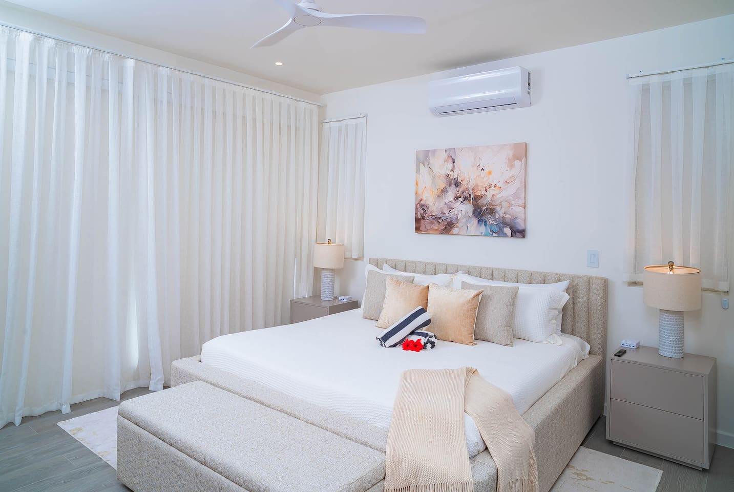 Master bedroom with king size bed, en-suite bathroom, air conditioning, ceiling fan, wall mounted tv, closet and gorgeous views of the ocean and hillside.