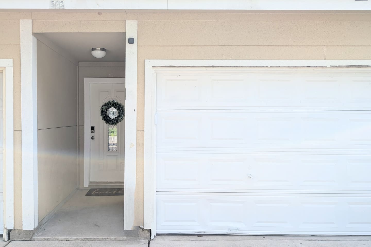 Guests enter through a private entrance located to the left of the garage. 