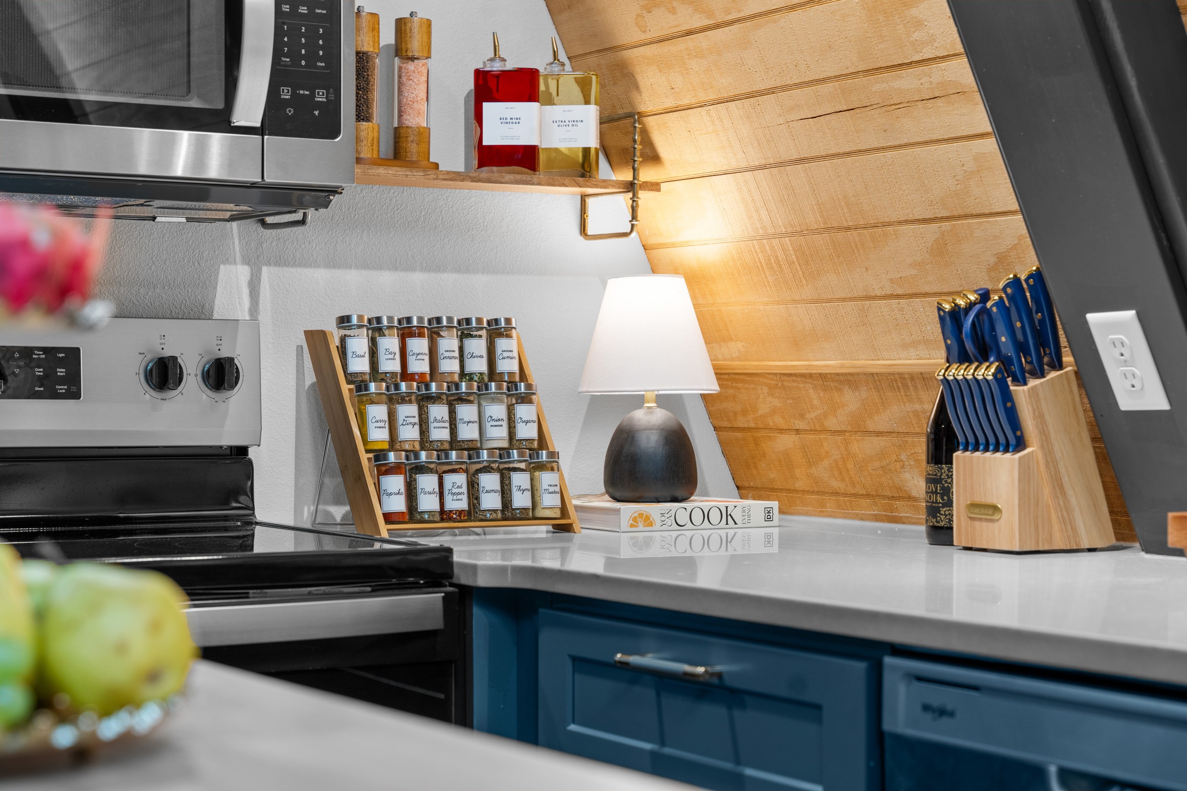 Kitchen corner with spice rack, knife block and olive oil. Everything you need to cook dinner together.