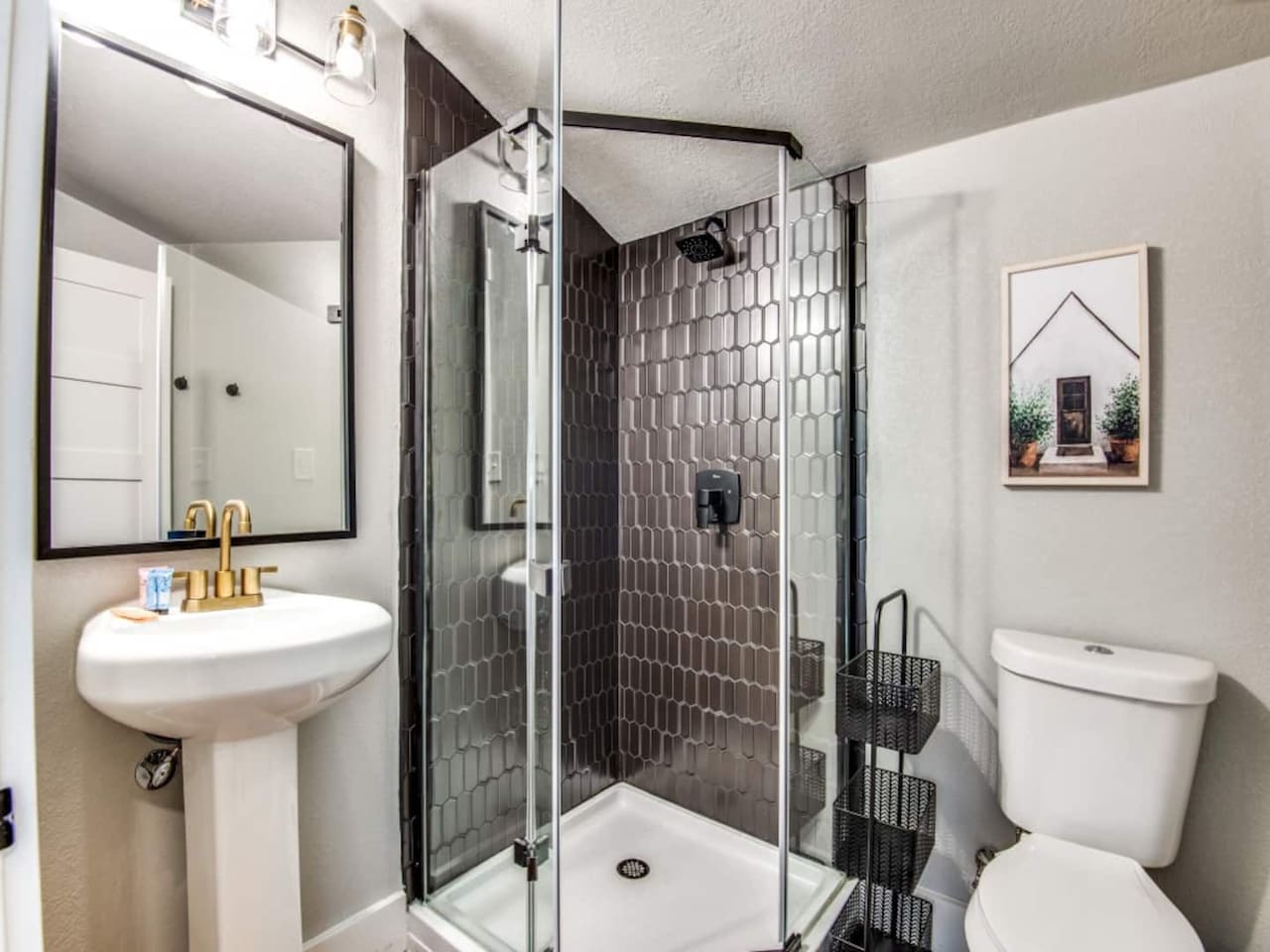 Walk-in shower, matte black fixtures, and frameless glass door. Stocked with shampoo, conditioner, and body soap.