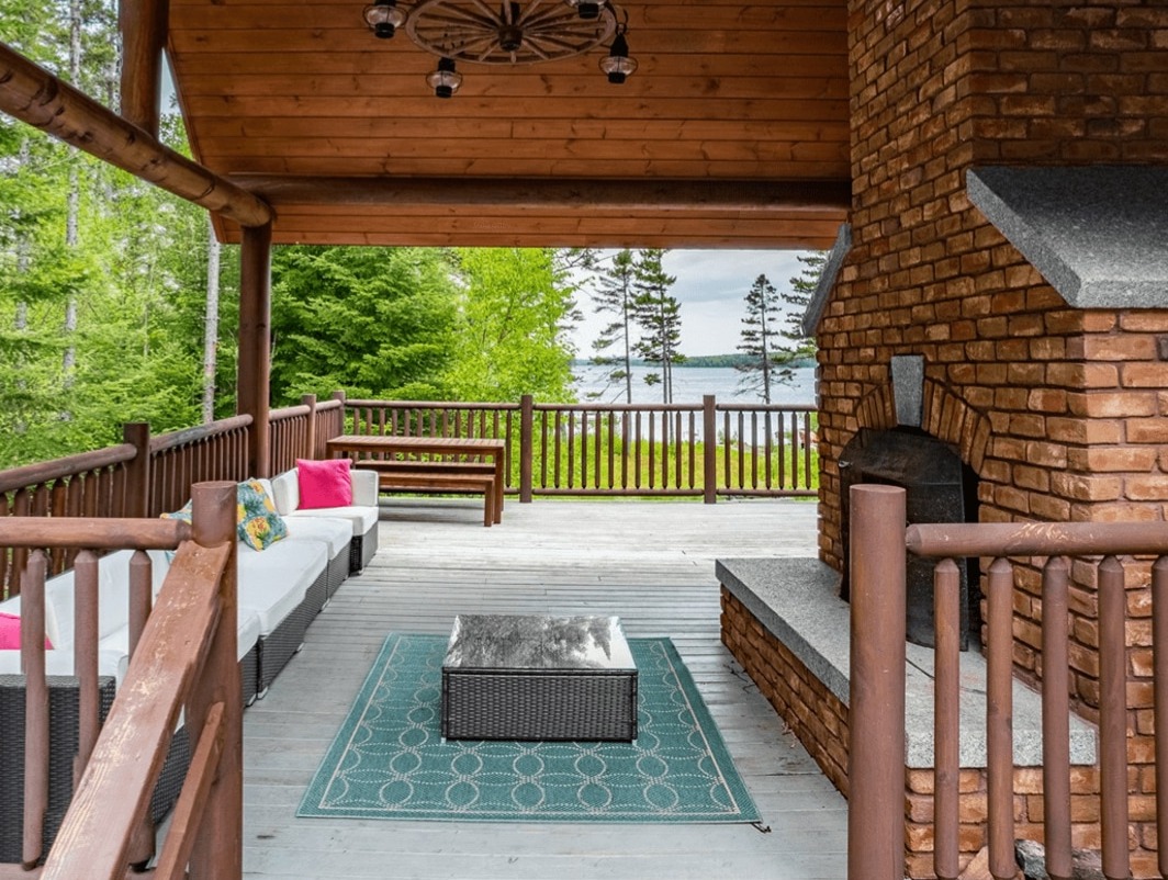 Living room with stone fireplace at Sebec Lake House