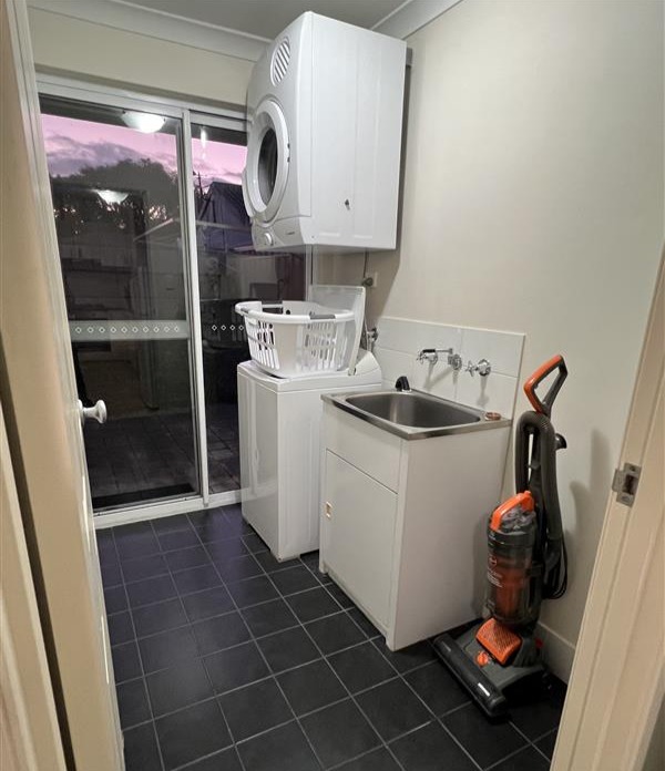 Spacious laundry with top load washing machine & clothes dryer