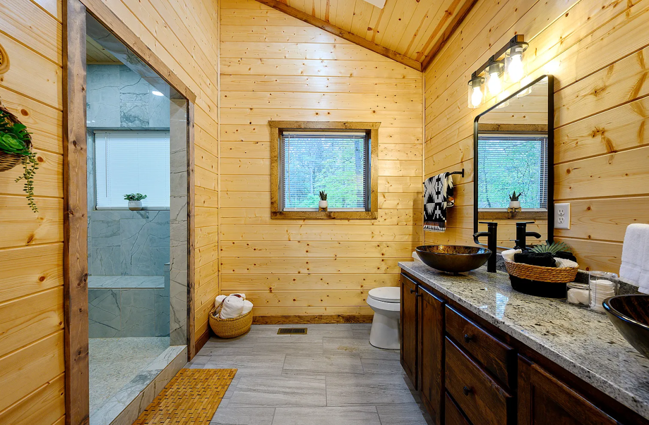 Large shared bathroom with double vanity and bright natural finishes