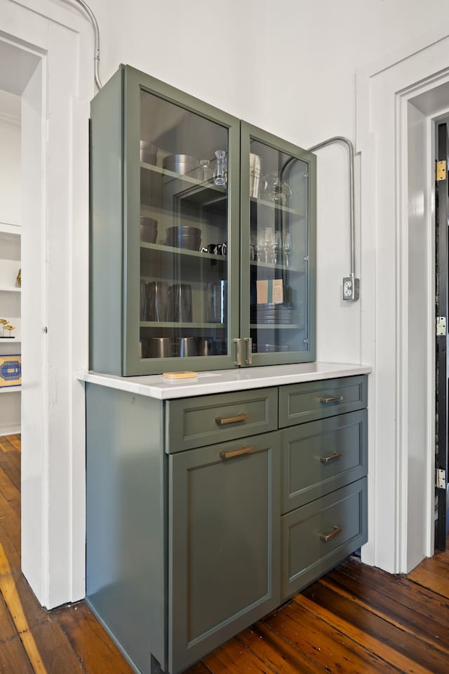 Plenty of kitchen storage stocked with dishes and other needful things.
