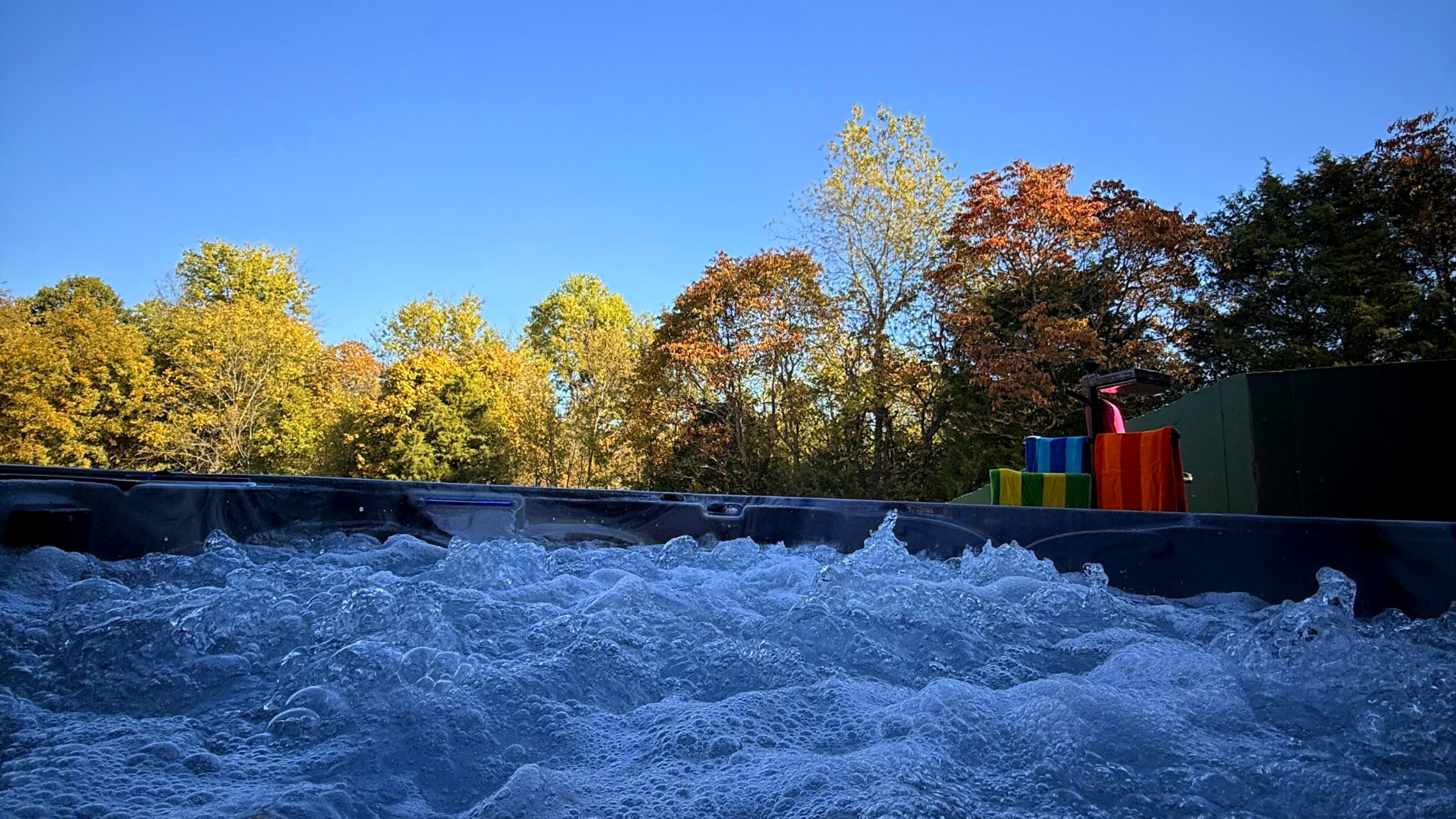 A crisp fall morning beside the hot tub — sunlight, steam, and serenity in the heart of bourbon country.