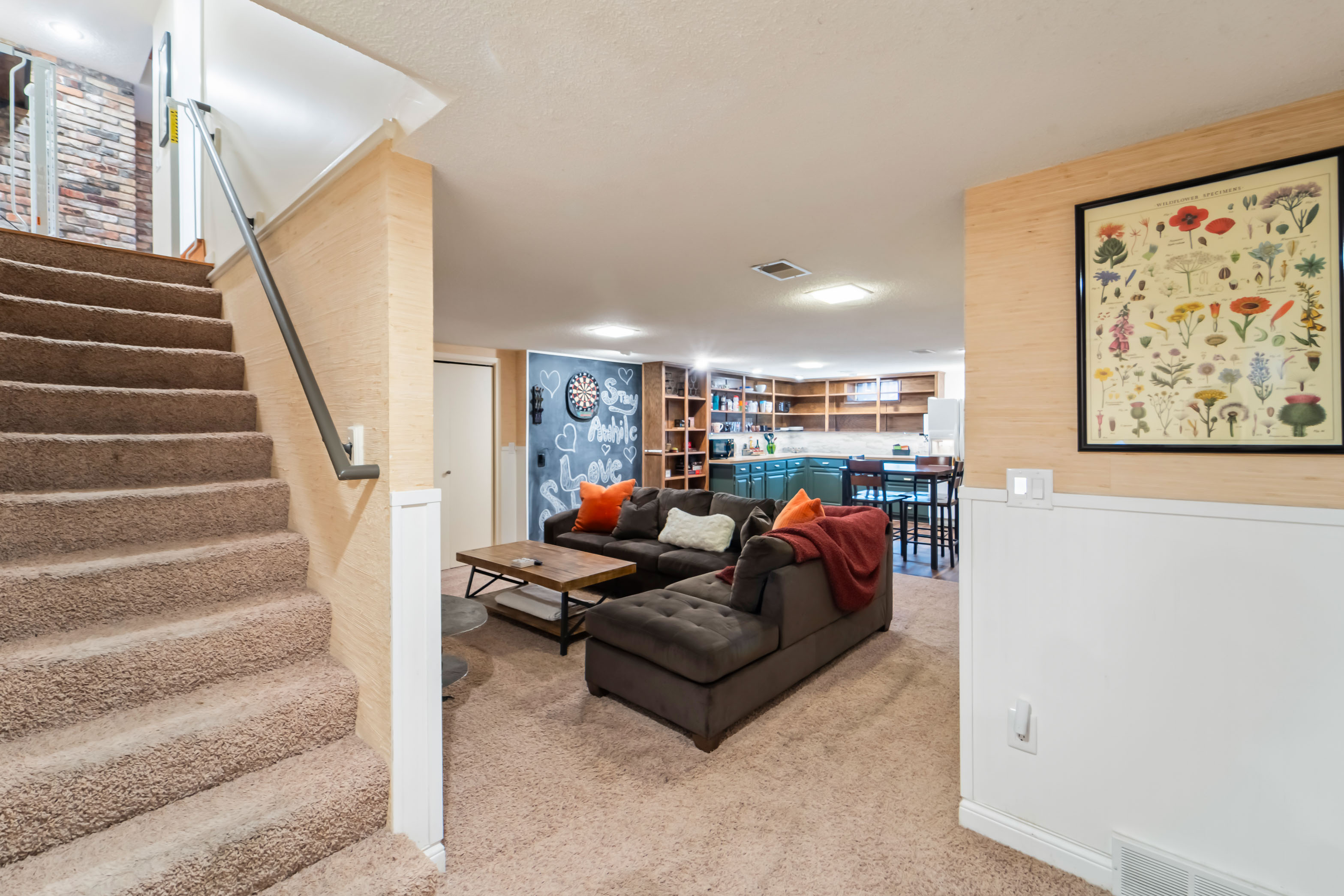 The downstairs living room is equipped with a comfy couch, plenty of puzzles and board games for the whole family. The kitchenette has extra cooking devices and a full sized fridge for the large family gatherings. There is a baby gate available to install.