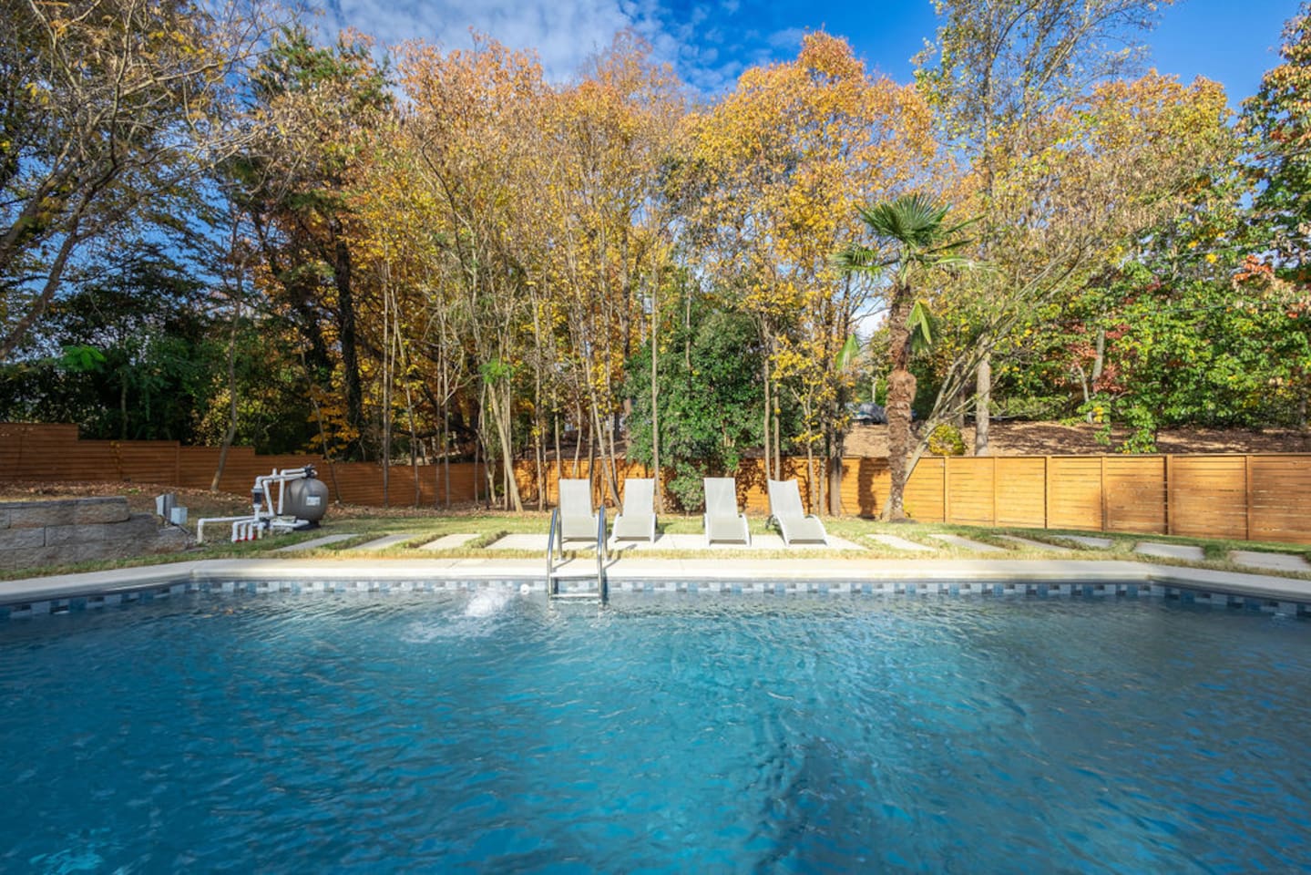 Stunning pool with a serene view of nature, allowing you to unwind in the water while enjoying the peaceful surroundings and natural beauty.