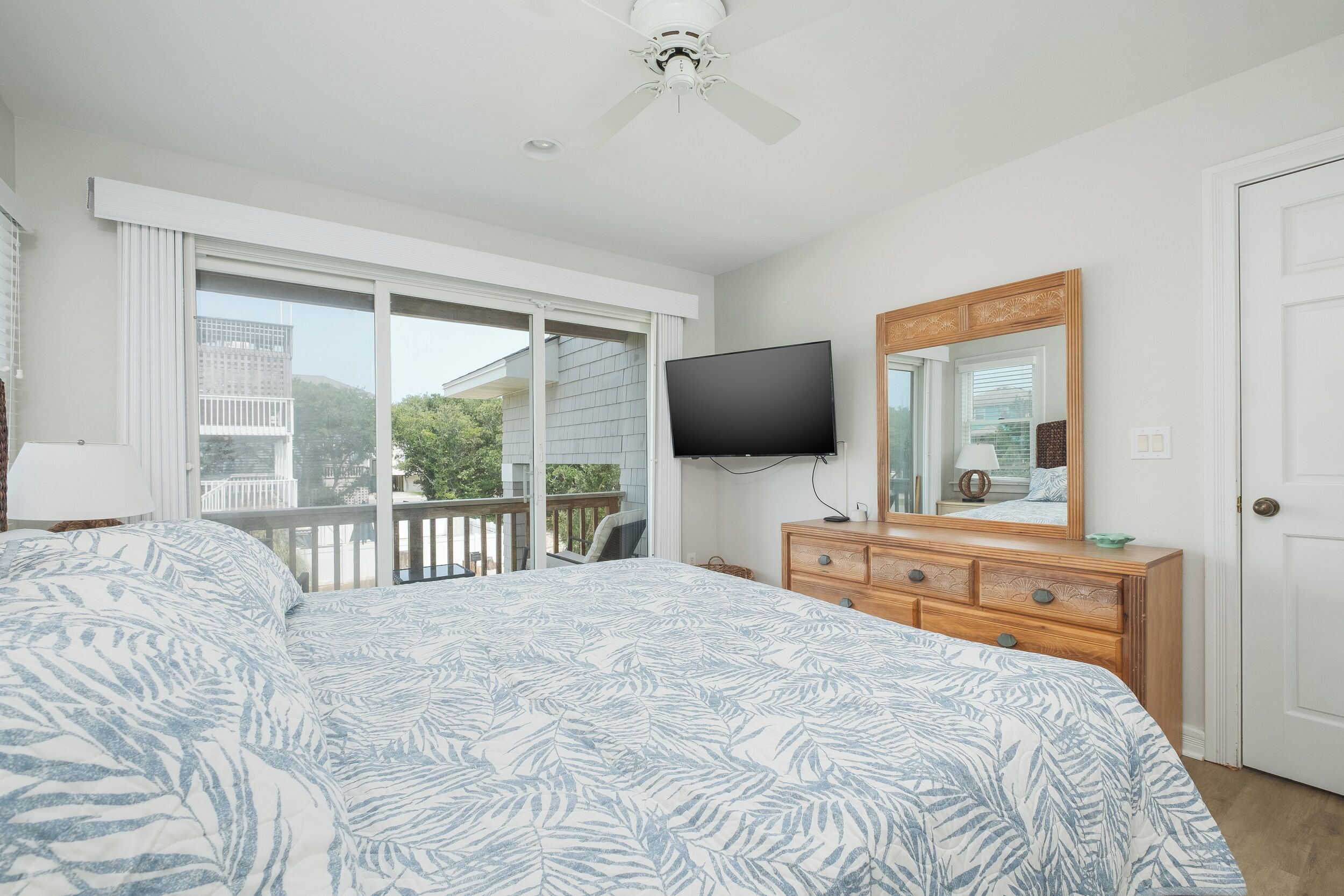 This bedroom is flooded with natural light, direct access to the 2nd level deck & Smart TV