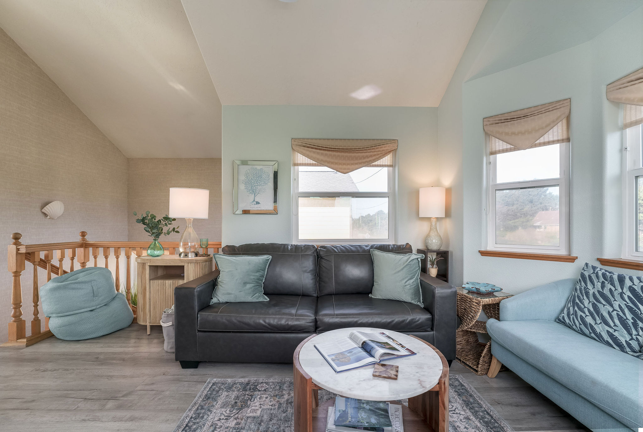 A well-lit, cozy living room interior with a queen sized pull-out sofa creates a comfortable area for the family to sit in. 
