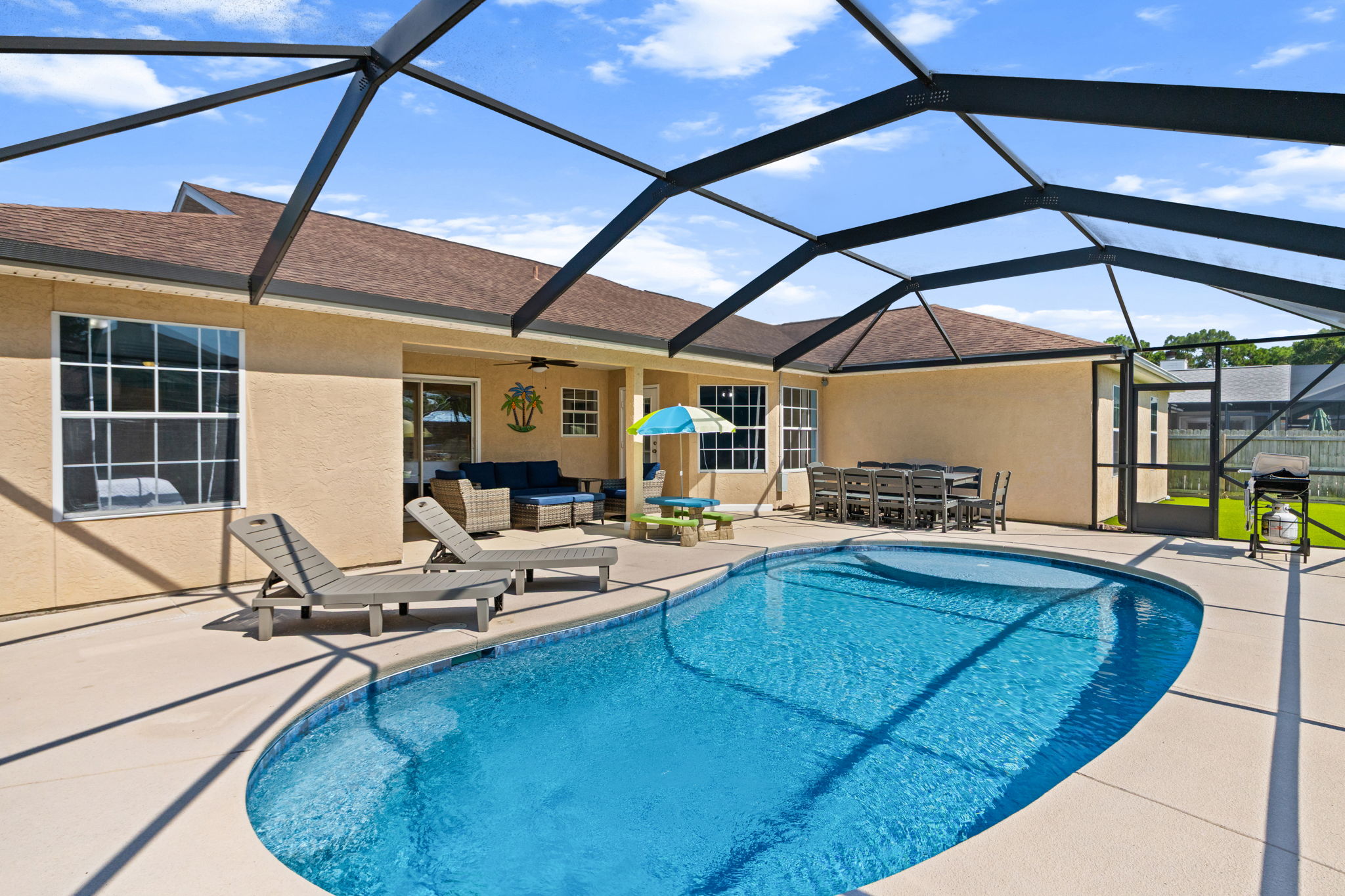 Your private poolside paradise awaits! This expansive, fully caged pool lanai is built for ultimate group entertainment. Enjoy a refreshing swim, soak up the sun on two comfortable loungers, or fire up the grill for an outdoor feast.