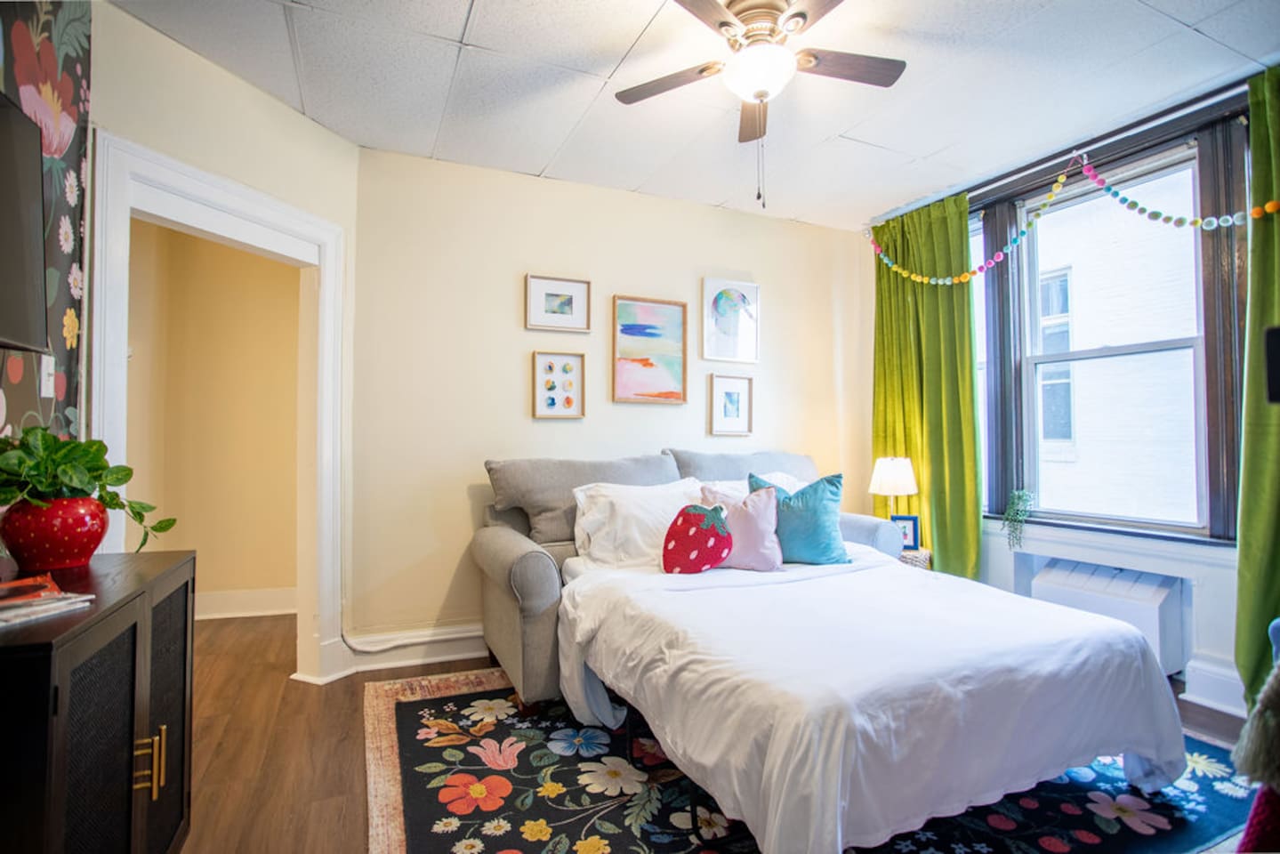 Bright and spacious living room featuring a comfortable sofa bed, perfect for relaxing or accommodating extra guests.