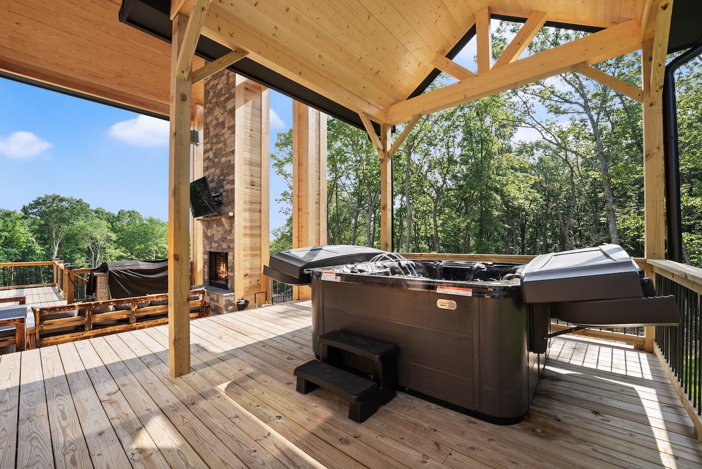 Soak in serenity in the large covered hot tub, ideally situated for both privacy and views of the surrounding trees.