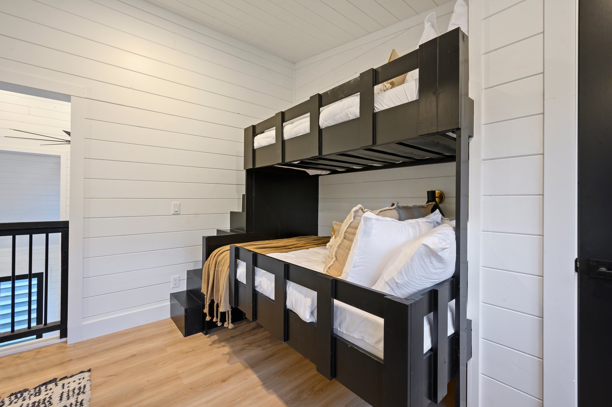 Custom bunk beds with built-in stairs make this space perfect for kids and teens.