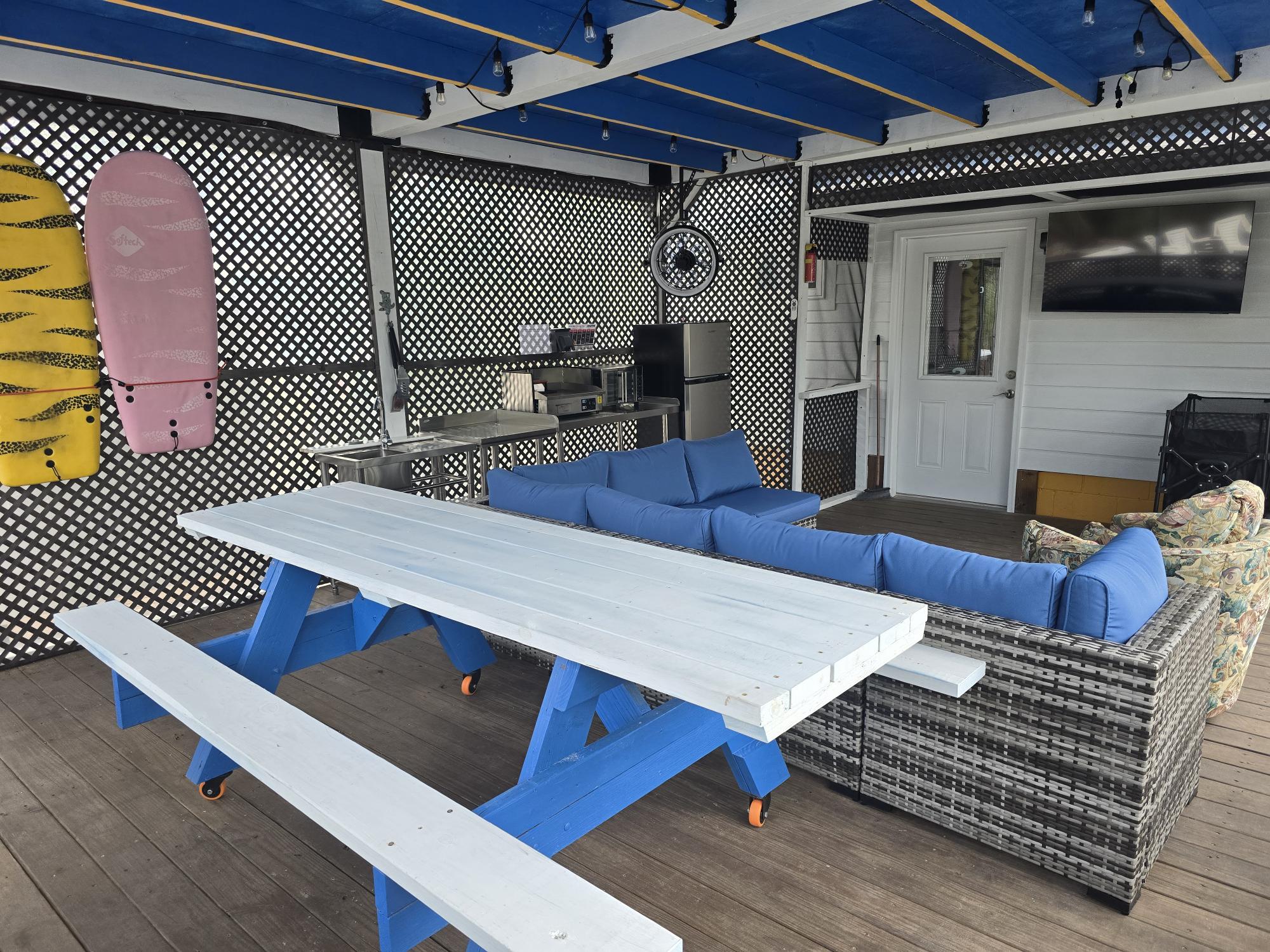 An oversized picnic table is also in the screened patio