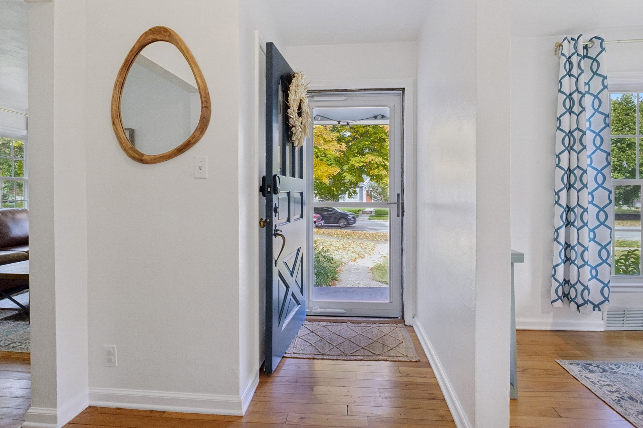 Step inside—our South Bend guest retreat entry features a warm-toned mirror with organic charm and a welcoming view of the beautiful front yard. A cozy first impression near Notre Dame.