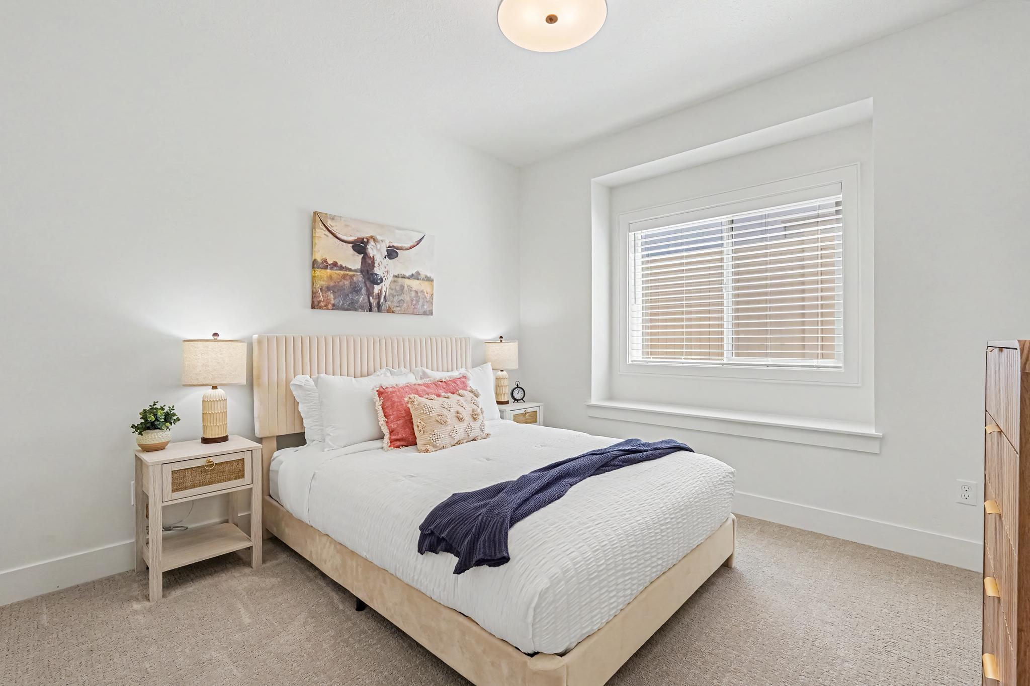 Relax and recharge in the middle bedroom with a cozy queen bed and thoughtful touches for your comfort.