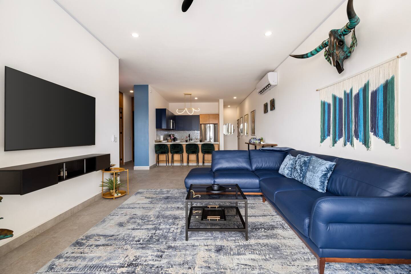 Enjoy the stunning view from the living room sliding glass door, seamlessly connecting the cozy living room and modern kitchen.