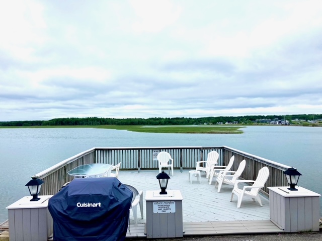 Property features a common deck by the water for sitting and relaxing