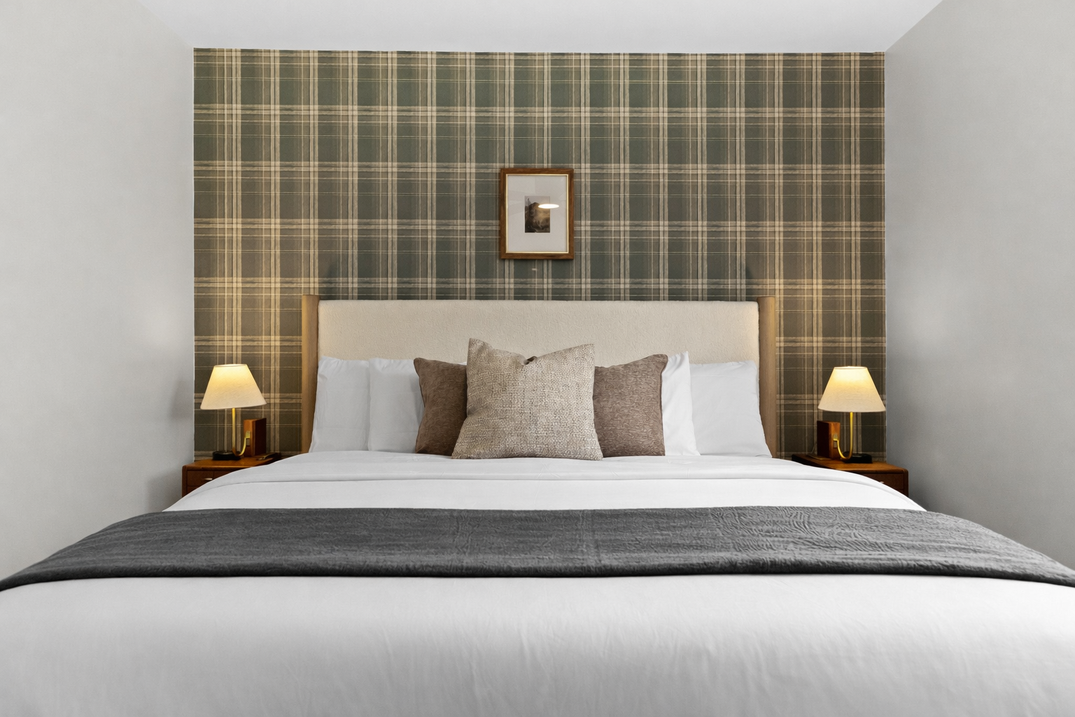 Cozy, well-appointed bedroom with a plush bed, soft lighting, and stylish accent wall—perfect for relaxing, recharging, and enjoying a peaceful night’s sleep.