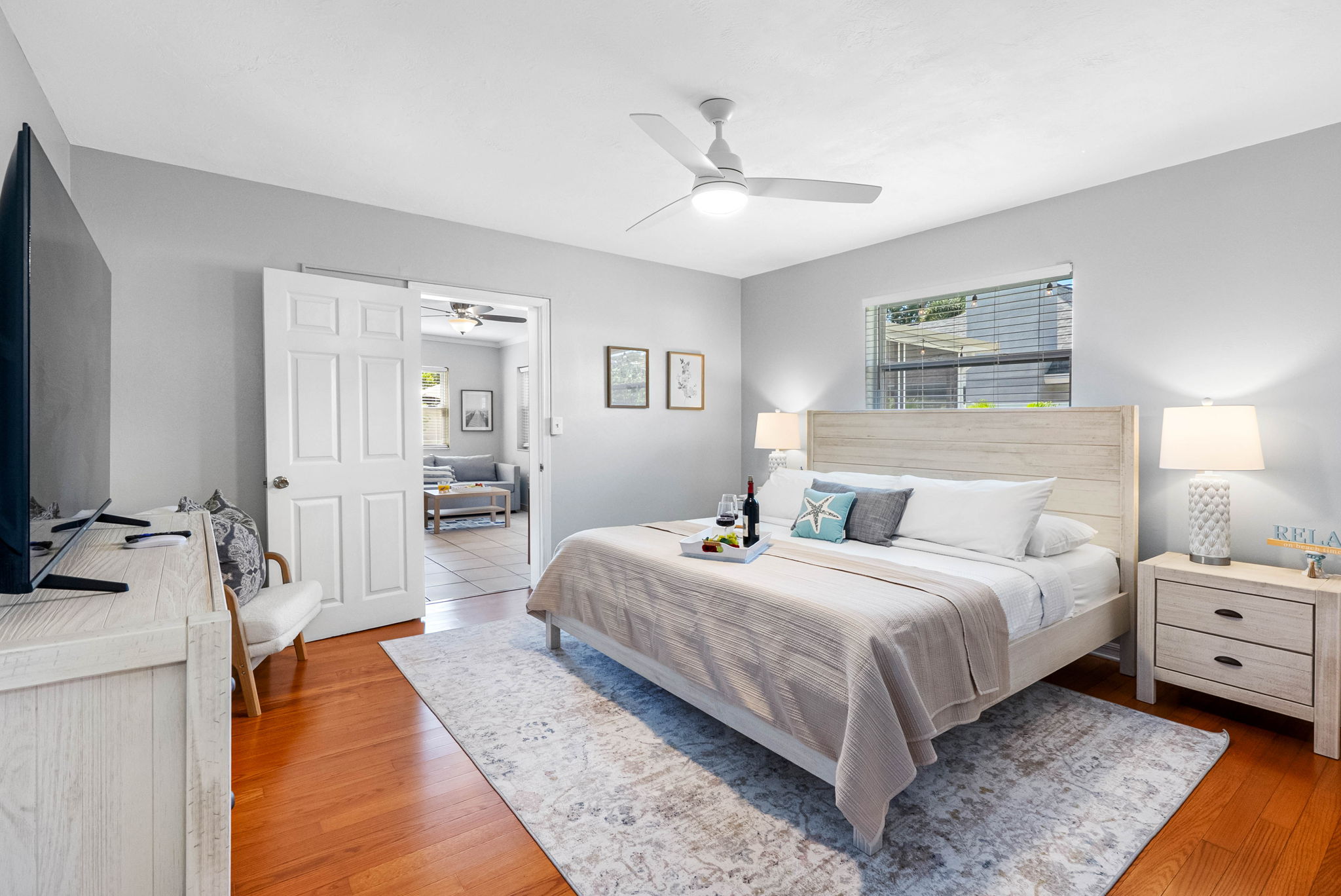 Coastal elegance meets comfort in this serene master suite with a king bed, soft textures, and soothing tones.