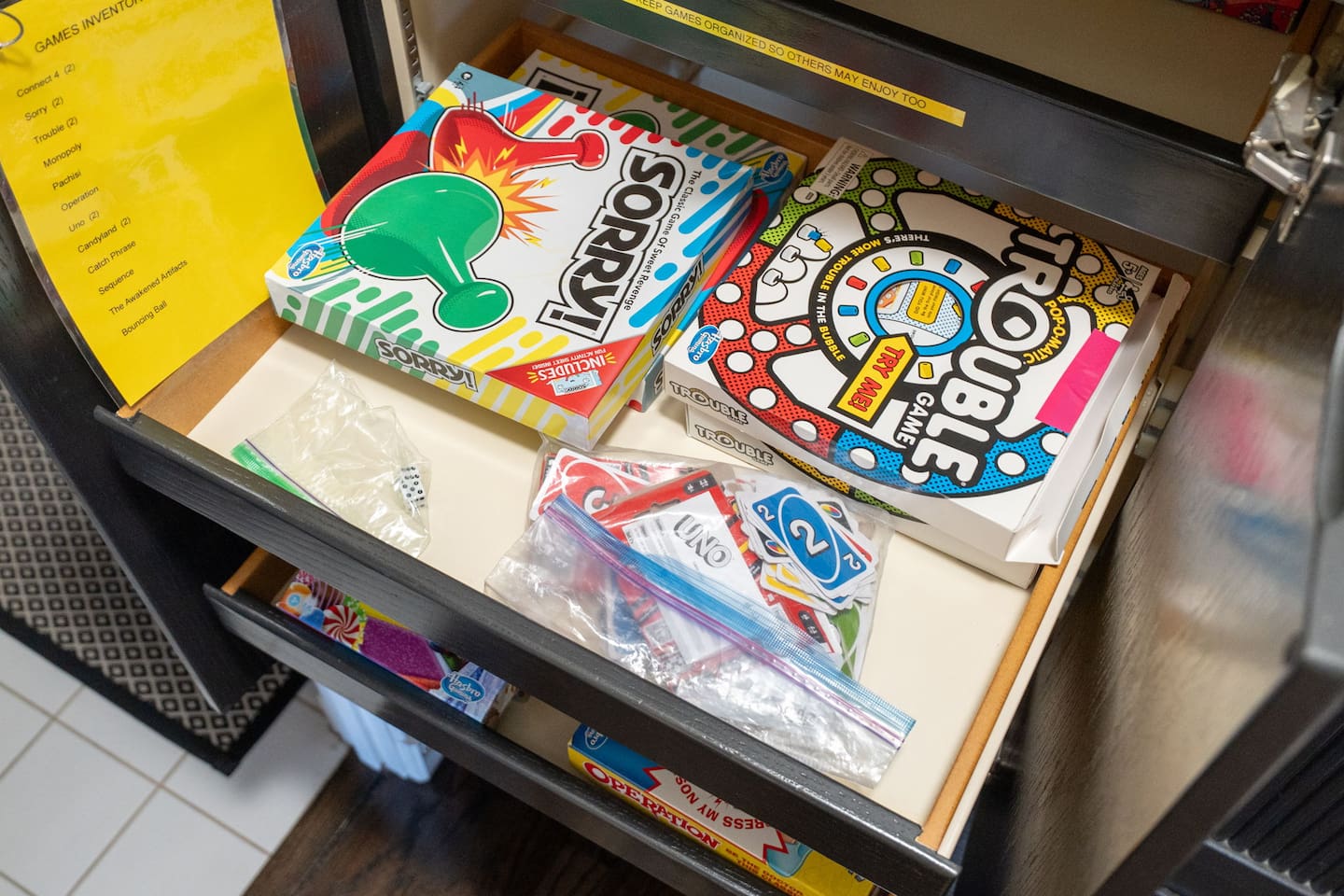 Relive childhood memories with classics like Sorry, Trouble, and Uno, perfect for game nights in the living area.