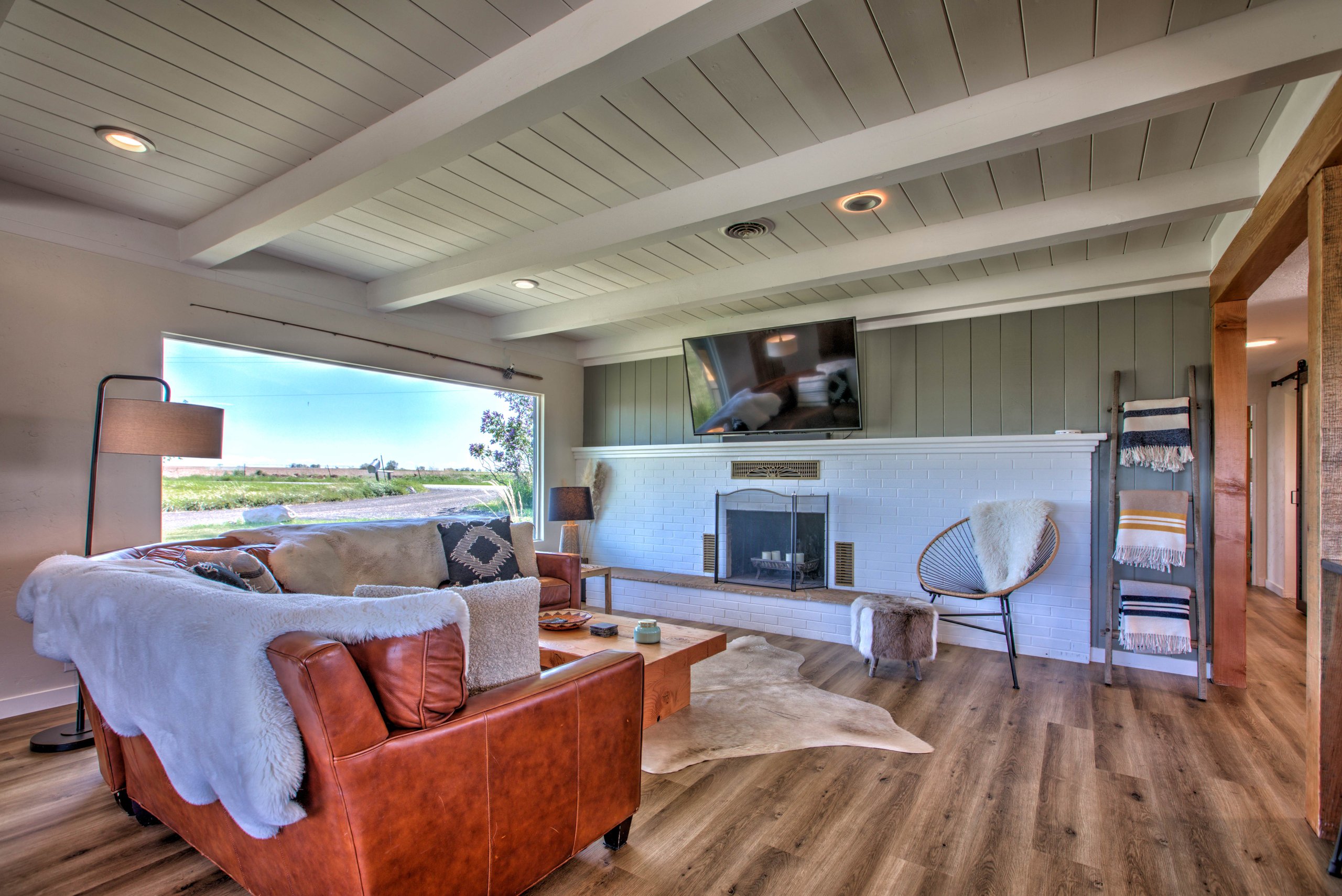 Relax by the big picture window overlooking the yard, farms, and canyon beyond