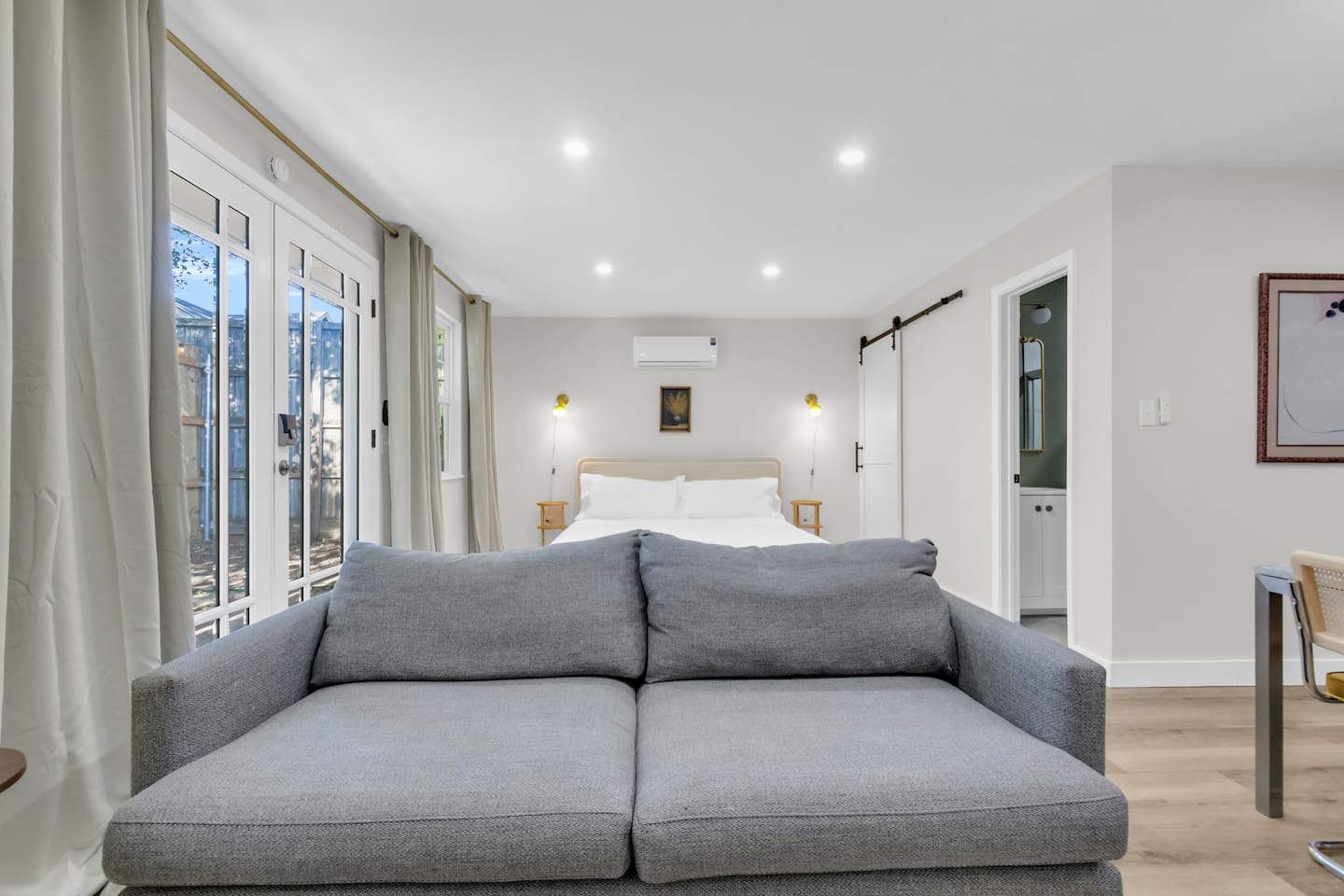 Spacious and bright 500 sq ft studio with a king bed, comfortable sofa, TV, and fully equipped kitchen—ideal for extended stays or weekend getaways.