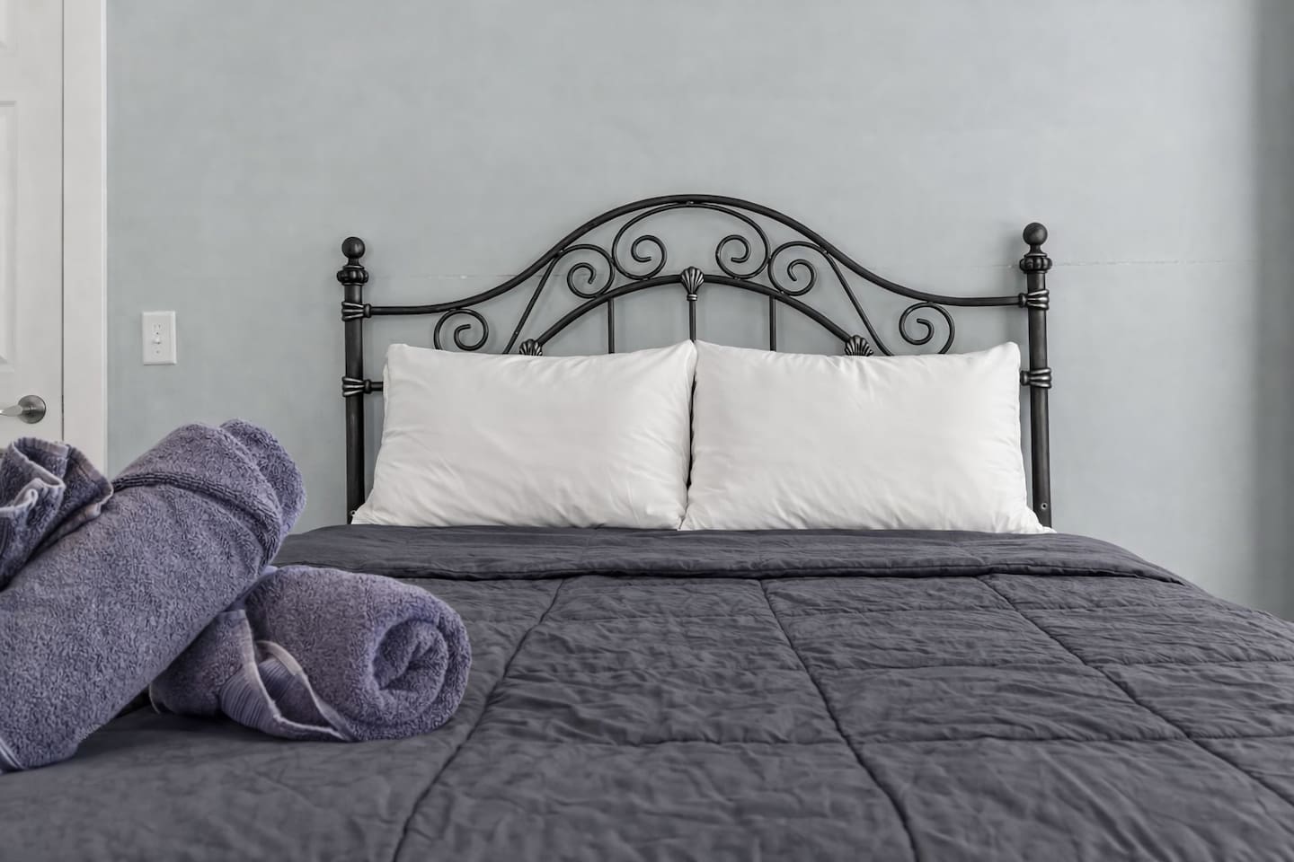 Centered bed view with neatly folded towels, creating a calm and restful sleeping atmosphere.