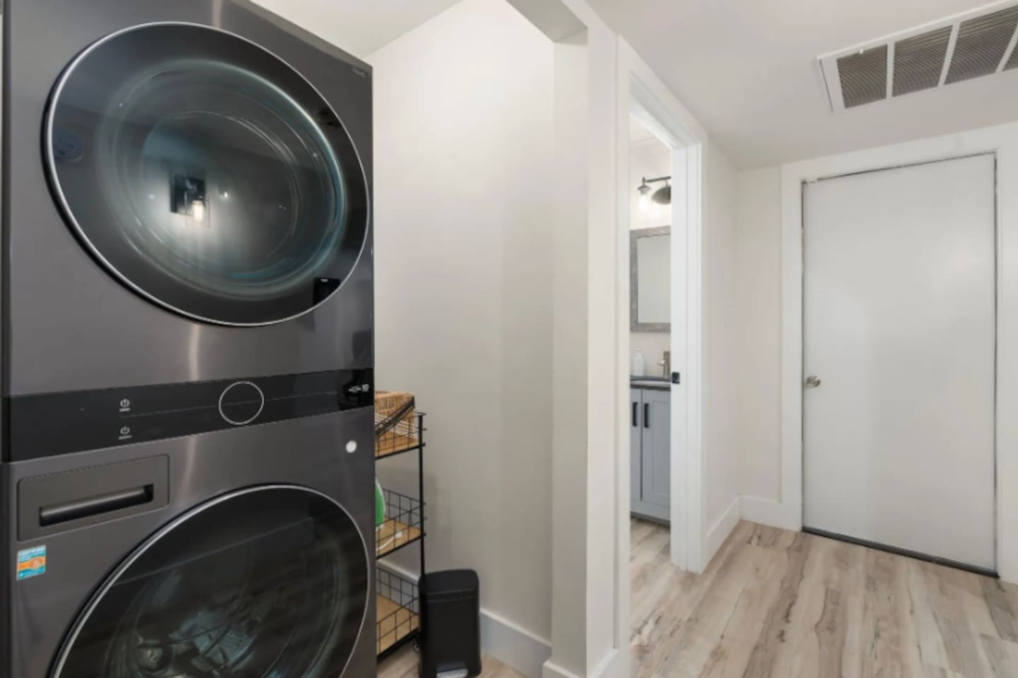 A stacked washer and dryer keep longer stays easy, tucked neatly just off the main hallway.
