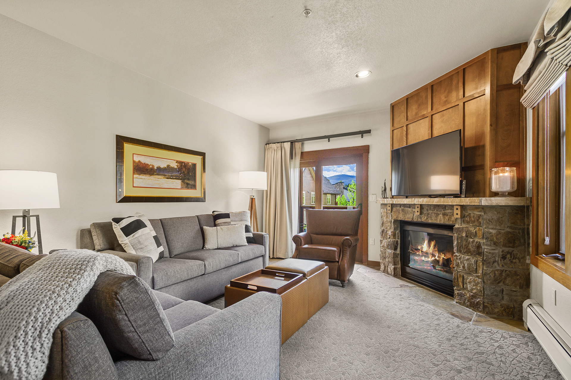 Living room with gas fireplace and deck