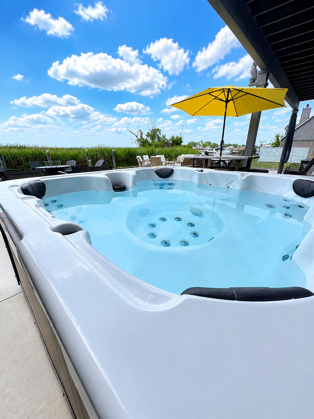 Relax in this inviting outdoor hot tub, perfectly set on a private waterfront patio. Surrounded by serene views and open sky, it’s the ideal spot to unwind after a day of exploring, offering a peaceful spa-like experience in a beautiful canal-side setting.