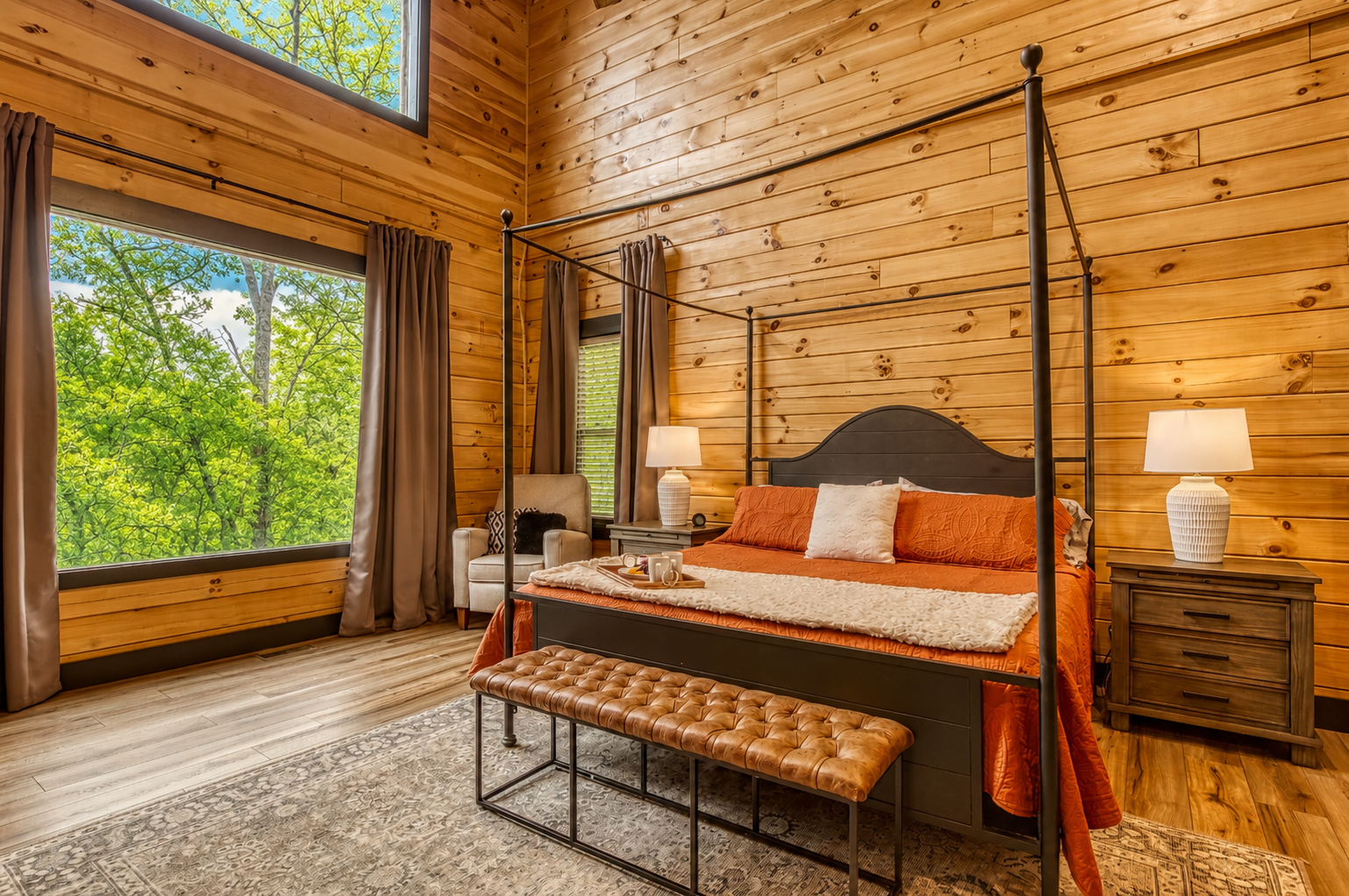 Wake up to soft morning light and peaceful forest views from this cozy, sunlit bedroom