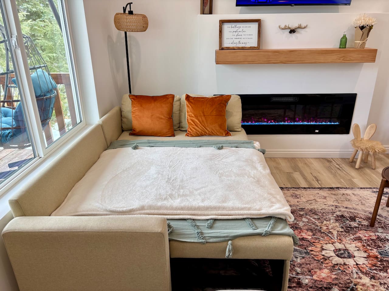 Wake up by the fireplace with forest views and coffee in bed — our sleeper sofa is made for slow mornings