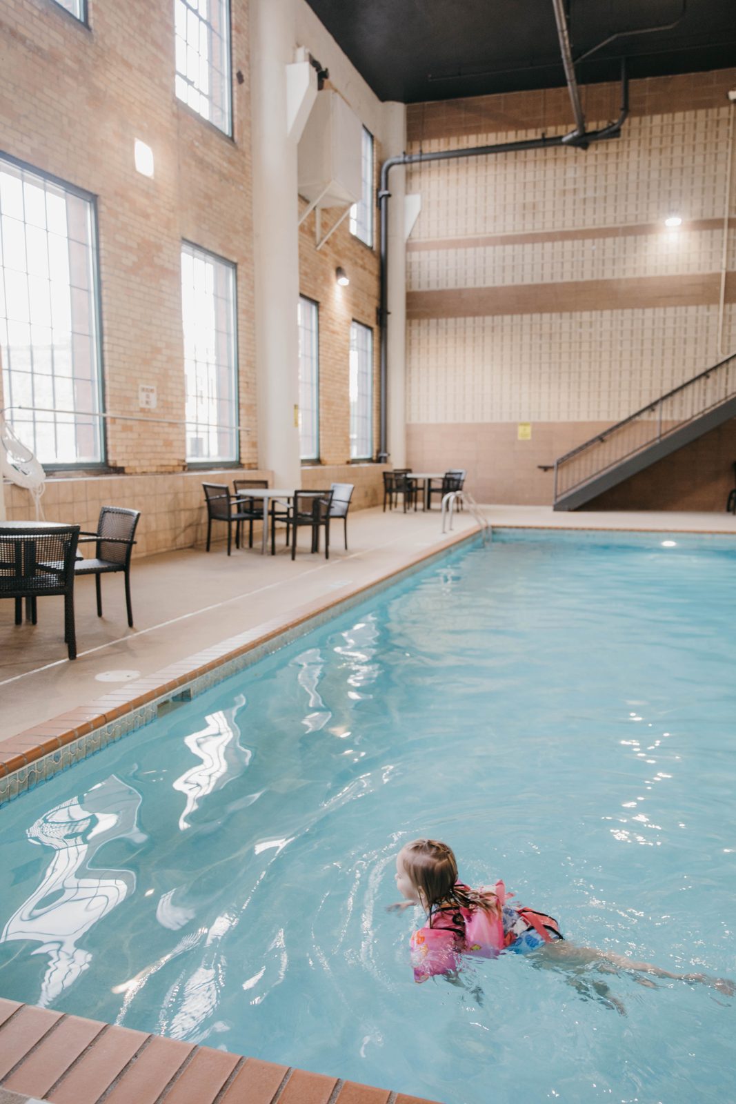 A child swimming in the indoor pool at the Waterfront Plaza building in Canal Park, Duluth