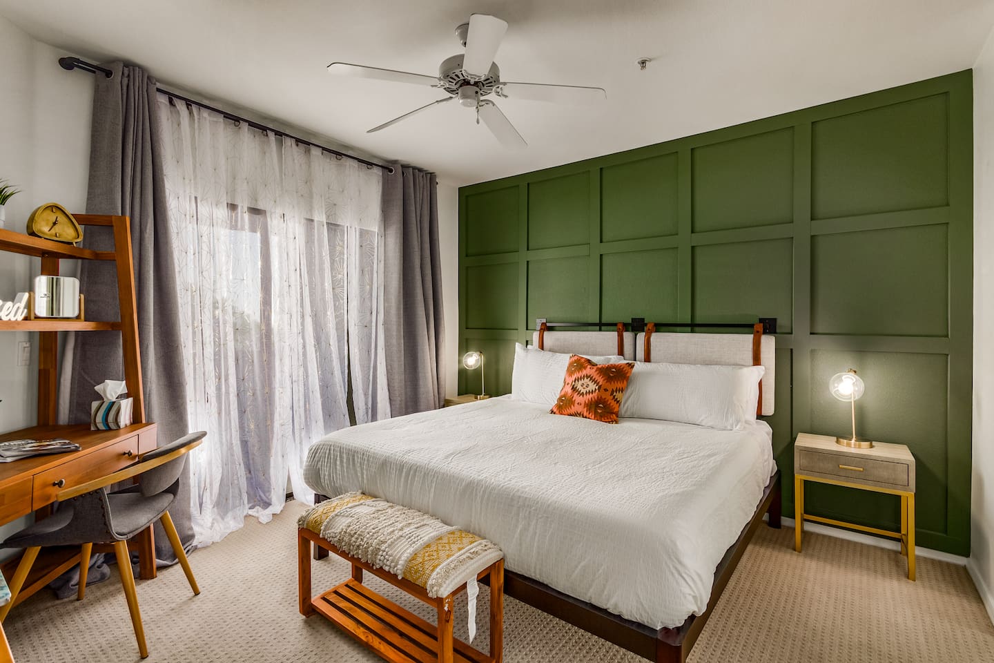 Spacious bedroom with king bed, workspace, and simple storage for short or extended stays.