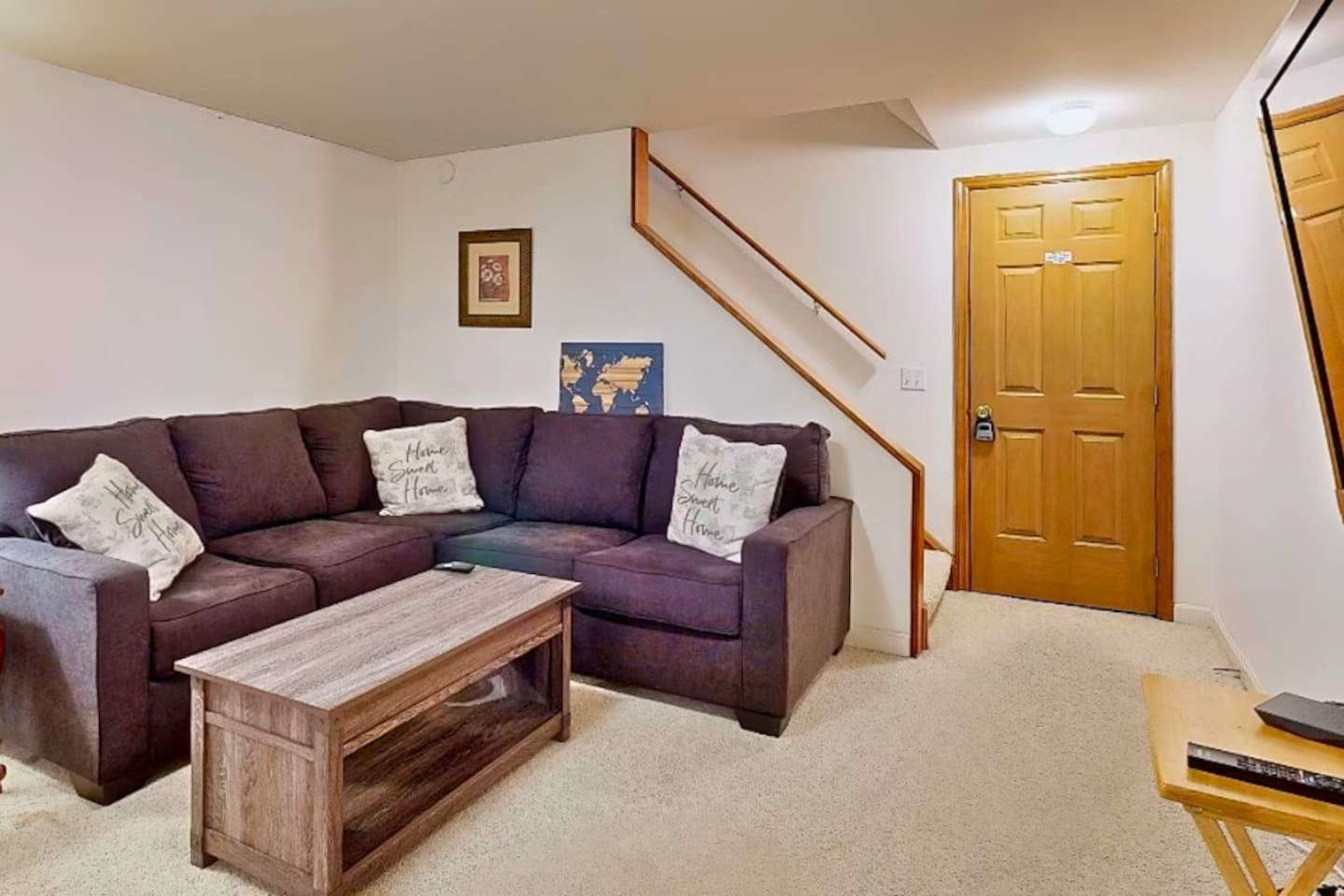 Second living room in basement with big screen TV.