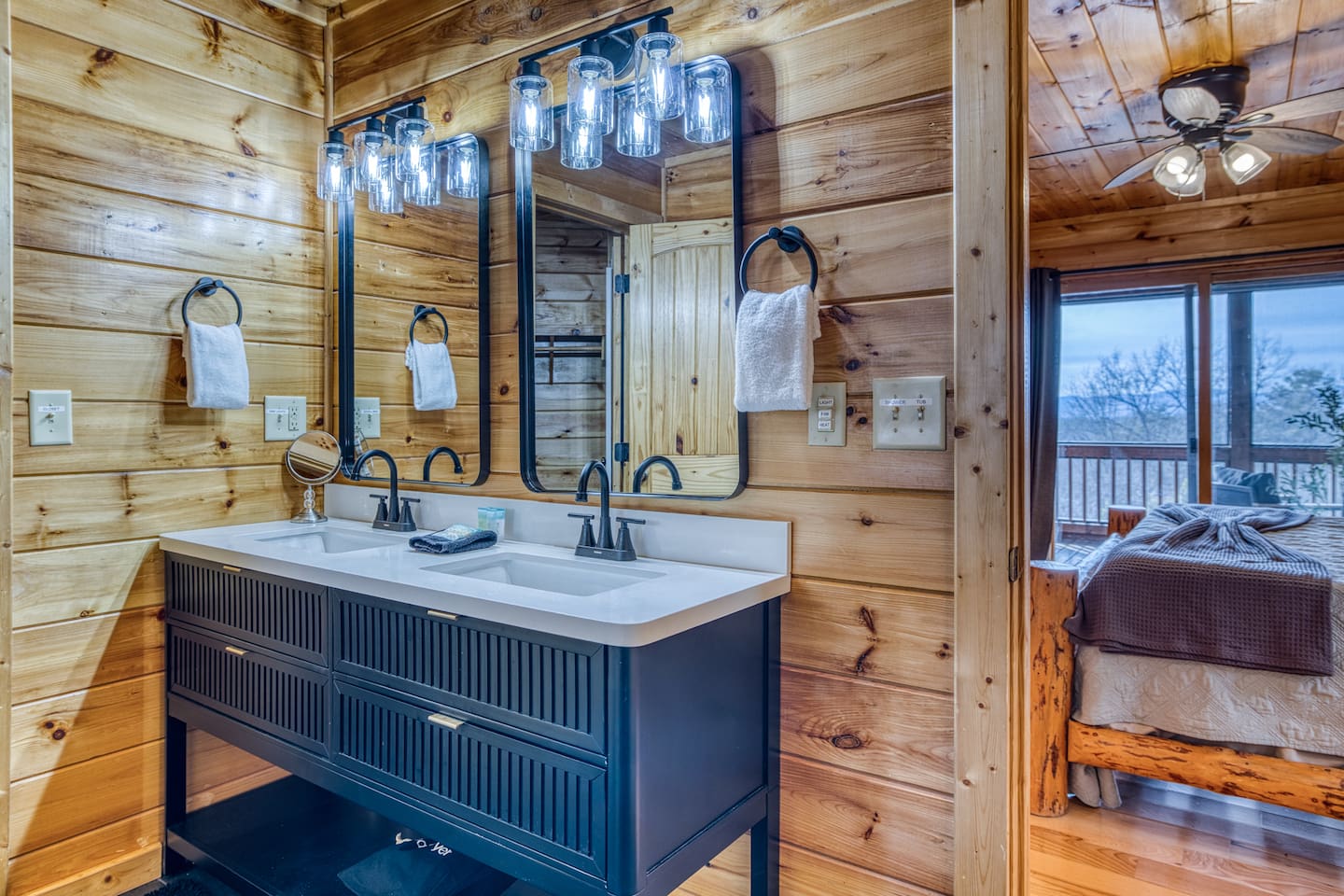 Main-level master bathroom includes double sinks, walk-in shower, jetted tub, separate toilet room, and walk-in closet.