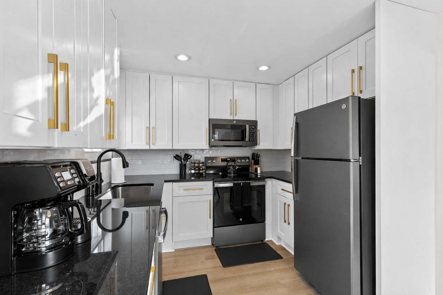 Cook with ease in this sleek, fully equipped kitchen featuring modern appliances, ample counter space, and bright cabinetry for a clean, inviting feel.